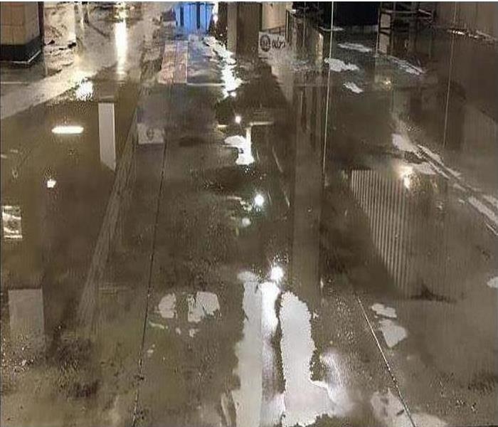 water reflecting off tile floor in commercial building, flooded