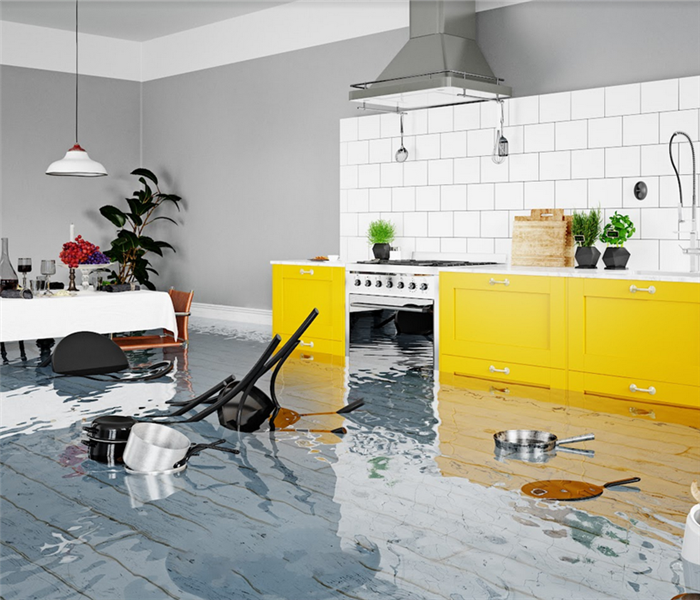 a flooded kitchen with water everywhere and furniture floating around